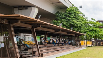 The covered spectator stand provides tiered seating looking onto the open lawn area and the sea beyond. The multi-level seating allows for people to sit individually or in groups in various positions to promote social interaction.